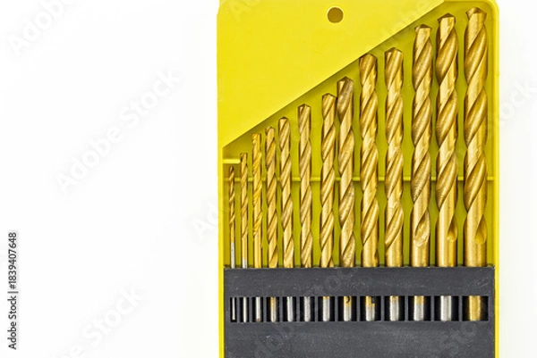 Obraz Set of gold drill bits in a bright yellow case for tool enthusiasts