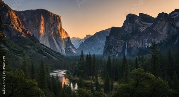 Fototapeta Massive granite monoliths frame a lush valley floor with a meandering river at sunset