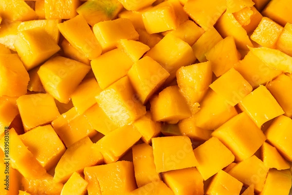 Obraz Peeled, ripe mango fruit pieces. Background texture.