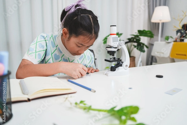Obraz Elementary Girl Placing Slide on Microscope STEM Science Experiment Procedure