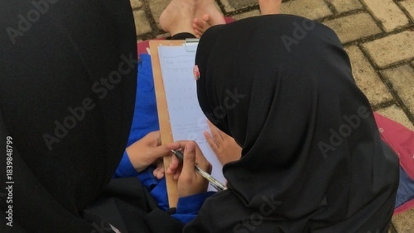 Obraz Mother Supporting Daughter’s Study Time in the Park