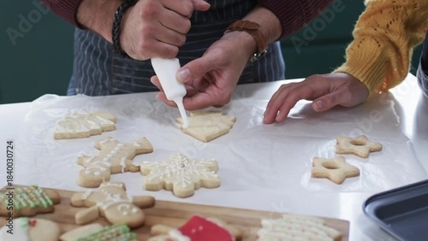 Fototapeta parent is decorating tree-shaped sugar cookie in flat design style, food theme featuring piping bag
