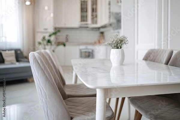 Fototapeta white modern apartment interior, dining room with table and chairs near the kitchen area. scandinavian-style home decor. minimalist design of living space in a white color scheme, 