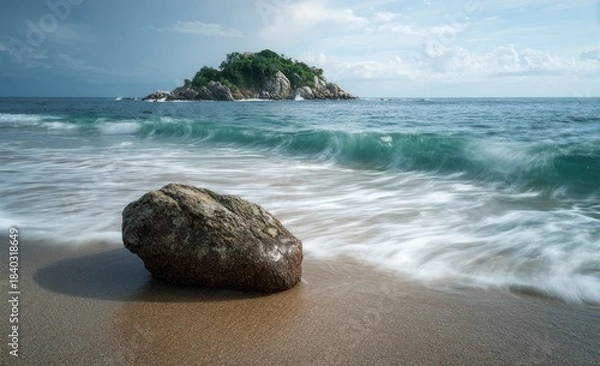 Fototapeta Coastal scene with waves crashing on a sandy beach, a solitary rock, and an island afar