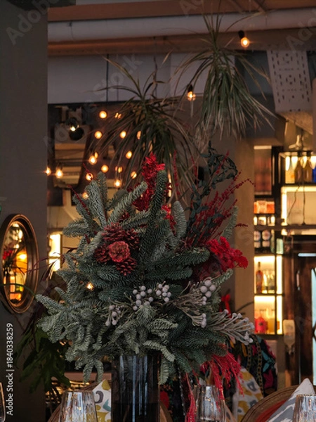 Obraz Festive interior decor with decorated Christmas trees in warm public setting.