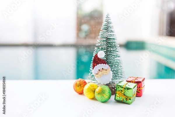Obraz Santa Clause with Christmas tree and ornament over blurred background, Christmas card background idea
