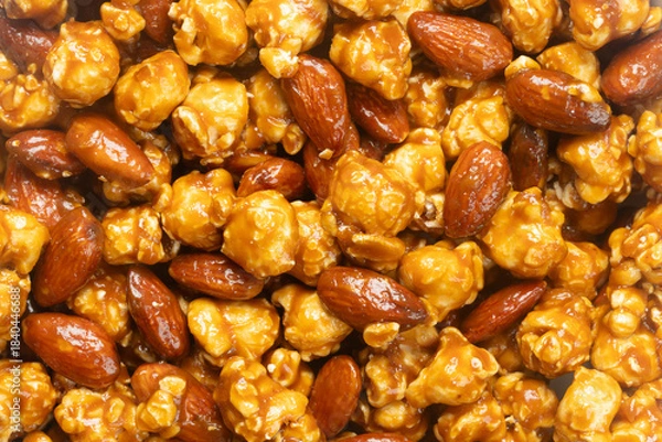 Fototapeta Top view of caramel popcorn with almonds for background