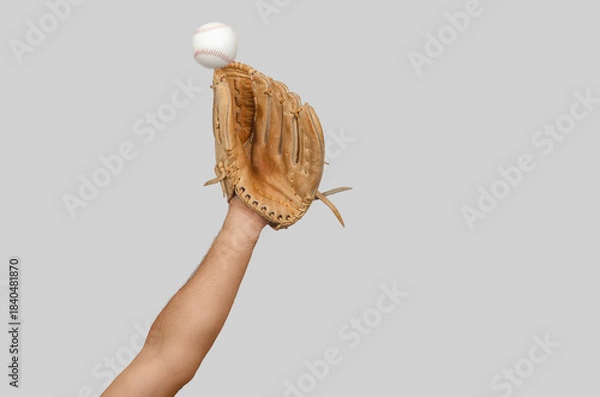 Fototapeta Arm extended with baseball glove ready to intercept moving ball, illustrating precision, reaction.