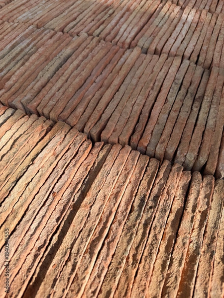 Fototapeta Rustic Red Terracotta Tile Stacks Forming a Repeating Diagonal Pattern