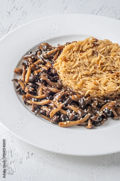 Obraz Savory fried rice topped with umami Shimeji mushrooms and golden sunny egg