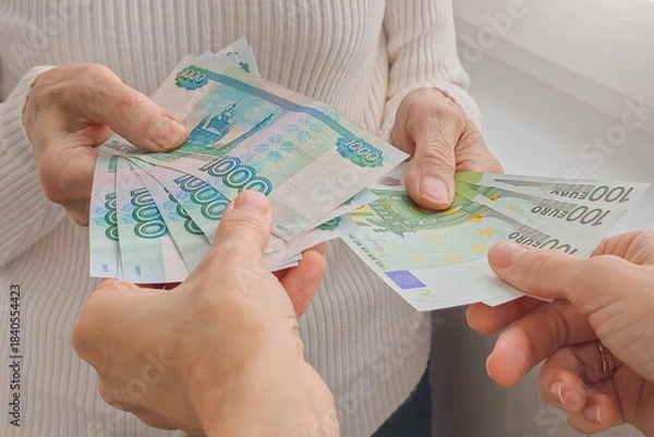 Fototapeta Exchange of rubles for euros. Banknotes in hand.