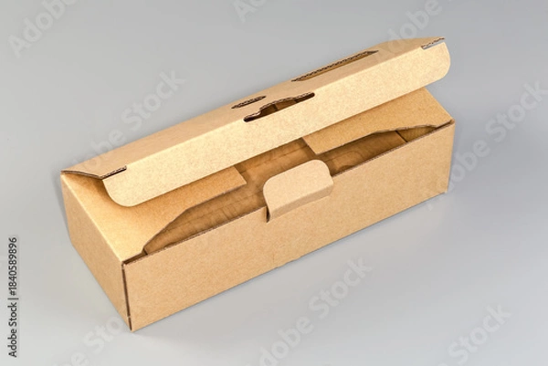 Obraz Partly open rectangular cardboard packing box on a gray background