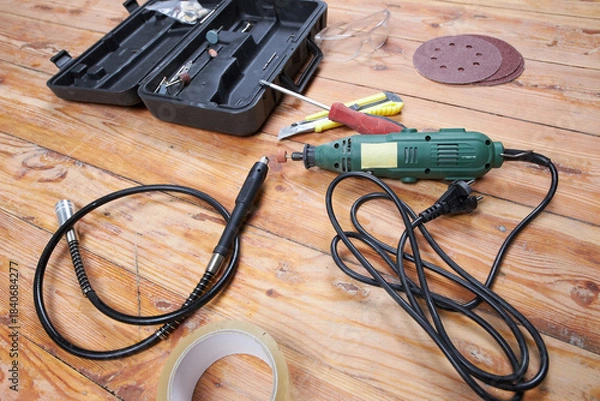 Obraz Working tools for repairs on a wooden floor.