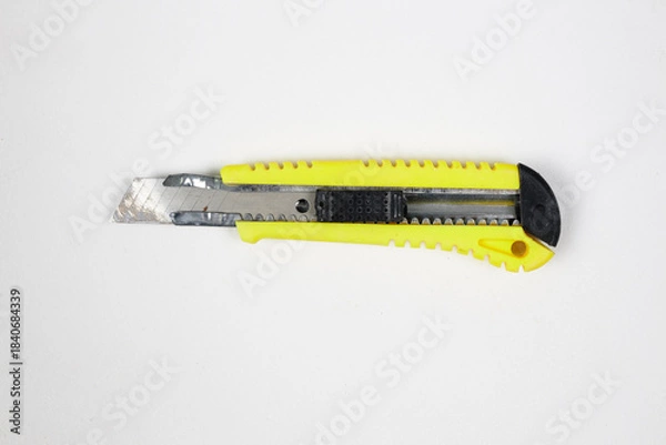 Obraz Old, broken construction knife with a yellow handle isolated on white background
