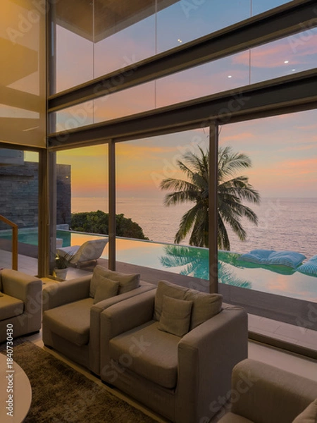 Fototapeta View from luxury villa at sunset, sun loungers for sunbathing, umbrellas from the sun, pillows for swimming in the pool, palm tree on background