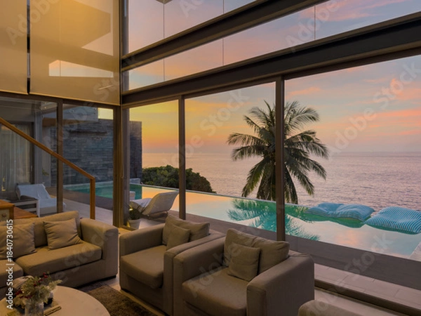 Fototapeta View from luxury villa at sunset, sun loungers for sunbathing, umbrellas from the sun, pillows for swimming in the pool, palm tree on background