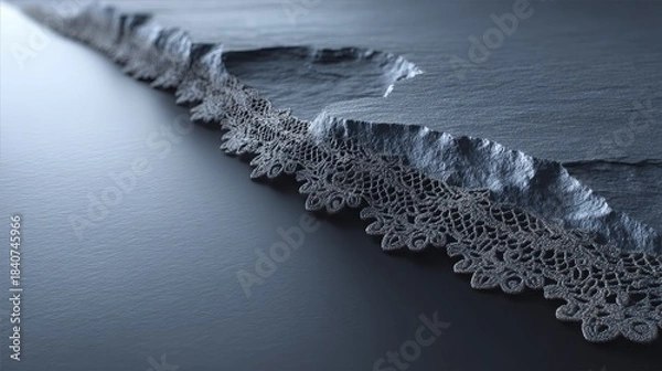 Fototapeta Close-up detail of intricate black mourning veil lace elegantly draped over a smooth slate surface, enhanced by soft cool lighting and dramatic shadows for a somber atmosphere