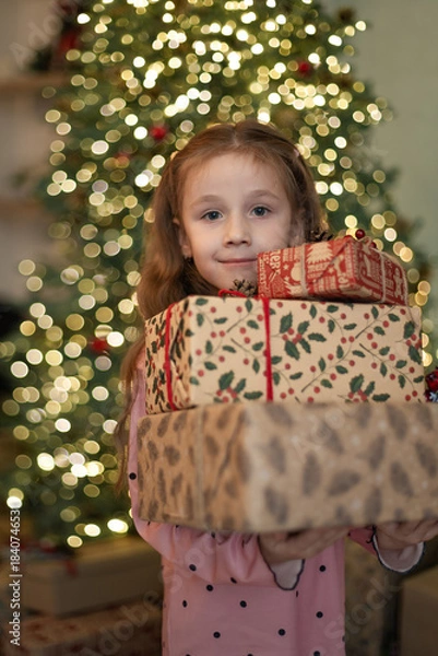 Obraz Little girl holding boxes with Christmas gifts,  Merry Christmas, winter holidays
