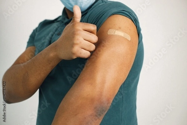 Fototapeta Black guy isolated on white background after covid vaccination