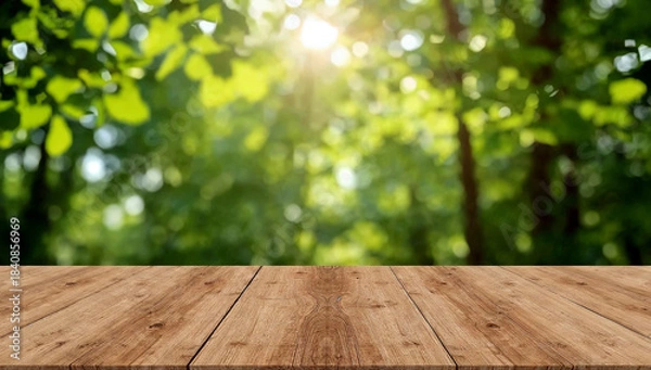 Obraz Empty wooden table under sunlit green foliage