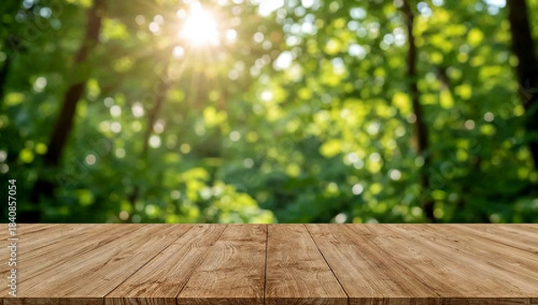 Obraz Empty wooden table under sunlit green foliage