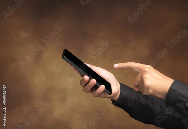 Obraz Man hand using smartphone touchscreen in studio background.