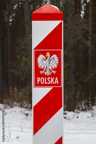 Obraz Border post with the emblem of the Polish. Border of Poland in winter.
