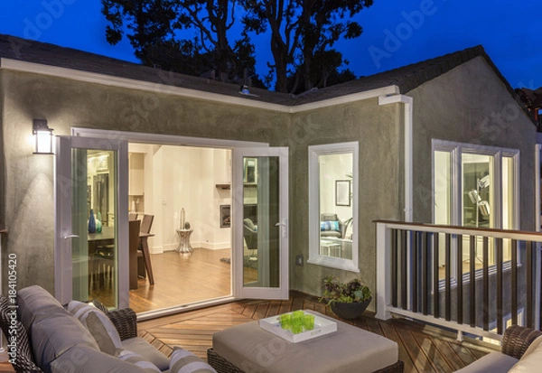 Obraz Home with furniture patio / wooden deck at twilight.