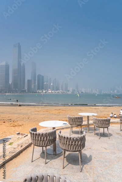 Fototapeta Tables and chairs as a lounge zone in the coastline of Qingdao, China
