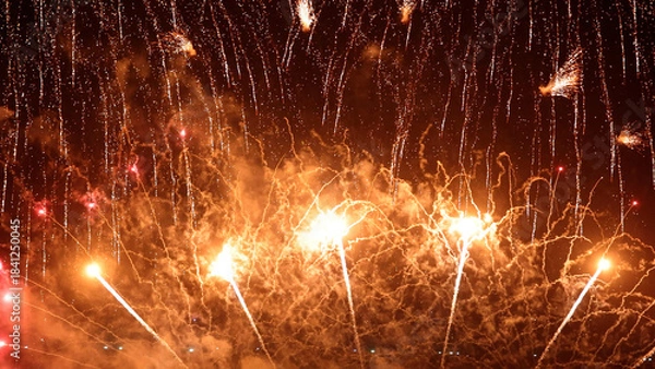 Obraz Amazing real beautiful colorful fireworks background on celebration night event for happy new year party, Abstract Multi color golden firework in the night sky