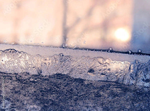 Obraz Beautiful ice pattern and sunlight on window glass, natural winter background