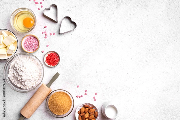 Fototapeta Valentine day baking background with heart shaped cookie cutters