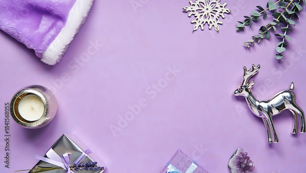 Fototapeta A chic and modern Christmas flat lay on a lavender background with a Santa hat, a candle, and silver ornaments.