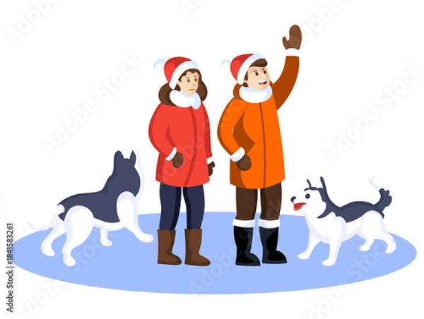 Fototapeta A couple in winter clothes with their two pet dogs enjoying a winter holiday.
