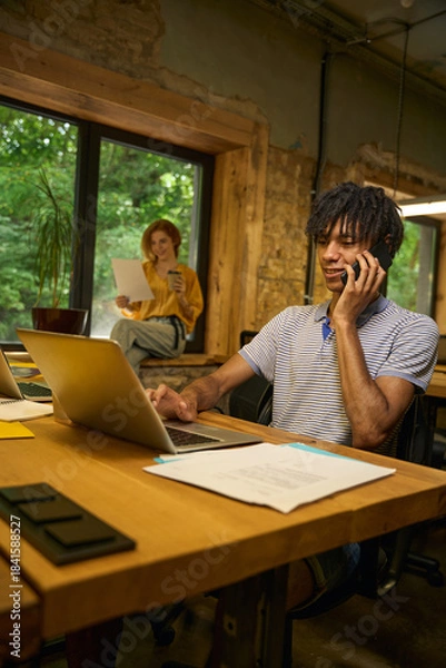 Obraz Man multitasking, phone call and laptop work