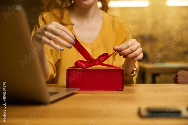 Obraz Close-up of hands opening a red gift box