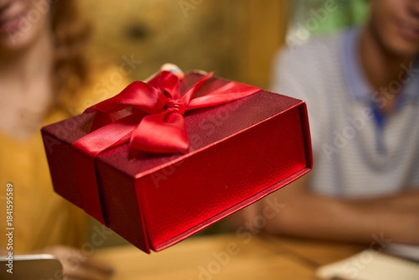 Obraz Red gift box with a ribbon in focus