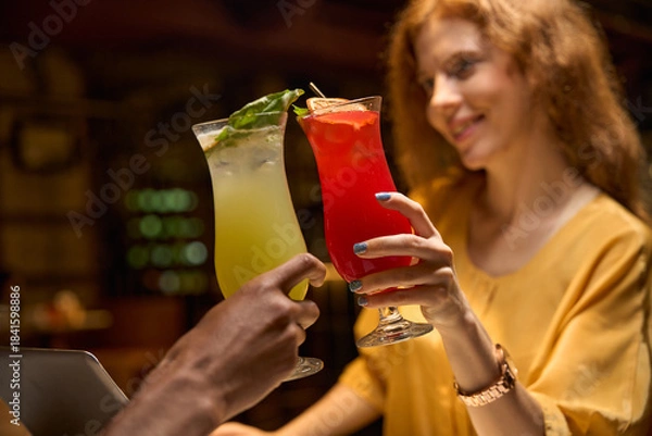 Obraz Adult woman holding a red drink, smiling