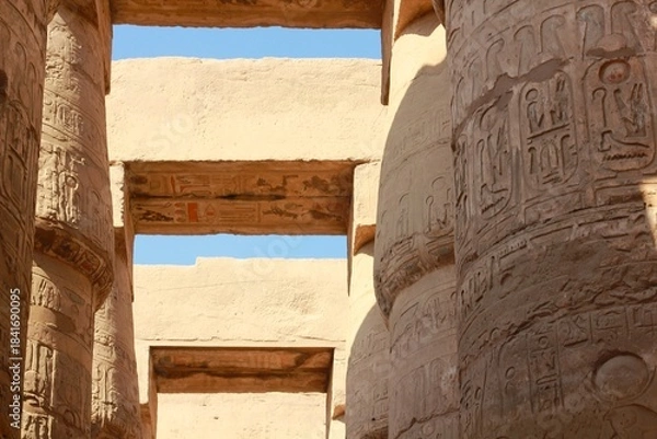 Fototapeta Ancient egyptian temple columns with hieroglyphic carvings. Karnak temple in Luxor, Egypt