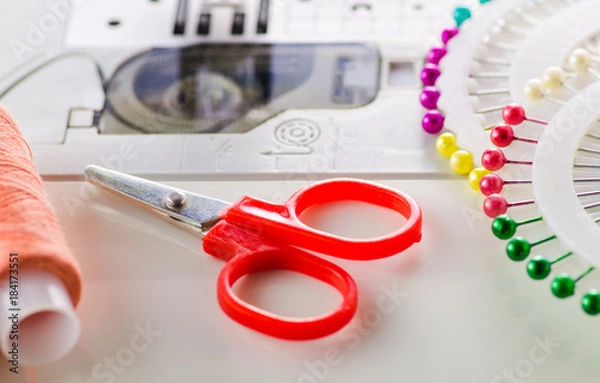 Obraz Scissors, needles, thread, a sewing machine closeup