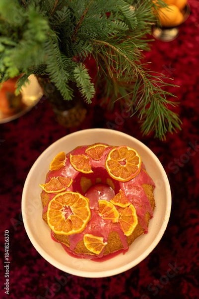 Obraz Christmas cookies on a plate. Festive cake decorated with dried oranges on a red velvet background
