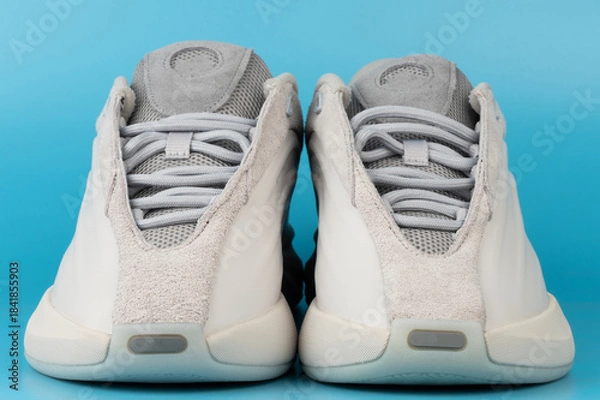 Obraz Sneakers displayed on a blue background for product viewing