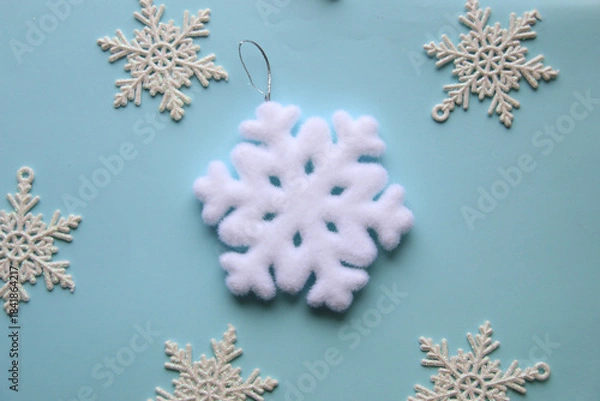 Obraz White snowflakes on a blue background.
