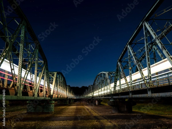 Obraz 夜空に光跡を残して走る列車と鉄橋の夜景
