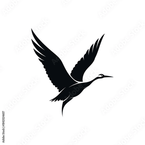Fototapeta Black silhouette of a graceful crane or heron-like bird in flight with wings spread against a white background.