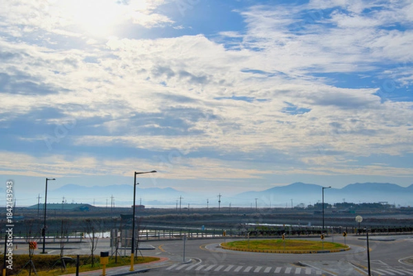 Fototapeta A road with a roundabout on a clear day