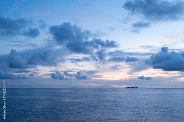 Obraz Container ship with lights on at sunset