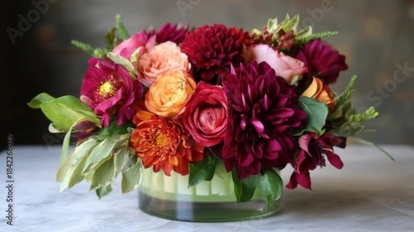 Fototapeta A colorful arrangement of flowers sits elegantly in front of a clean white surface,