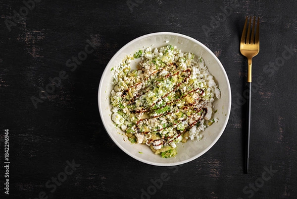 Fototapeta Avocado ricotta salad appetizer with soy sauce. Healthy food. Top view.