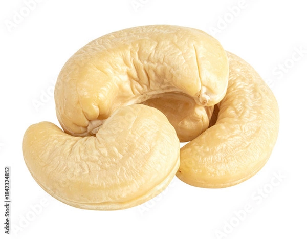 Fototapeta Three creamy, shelled nuts clustered together against a black backdrop